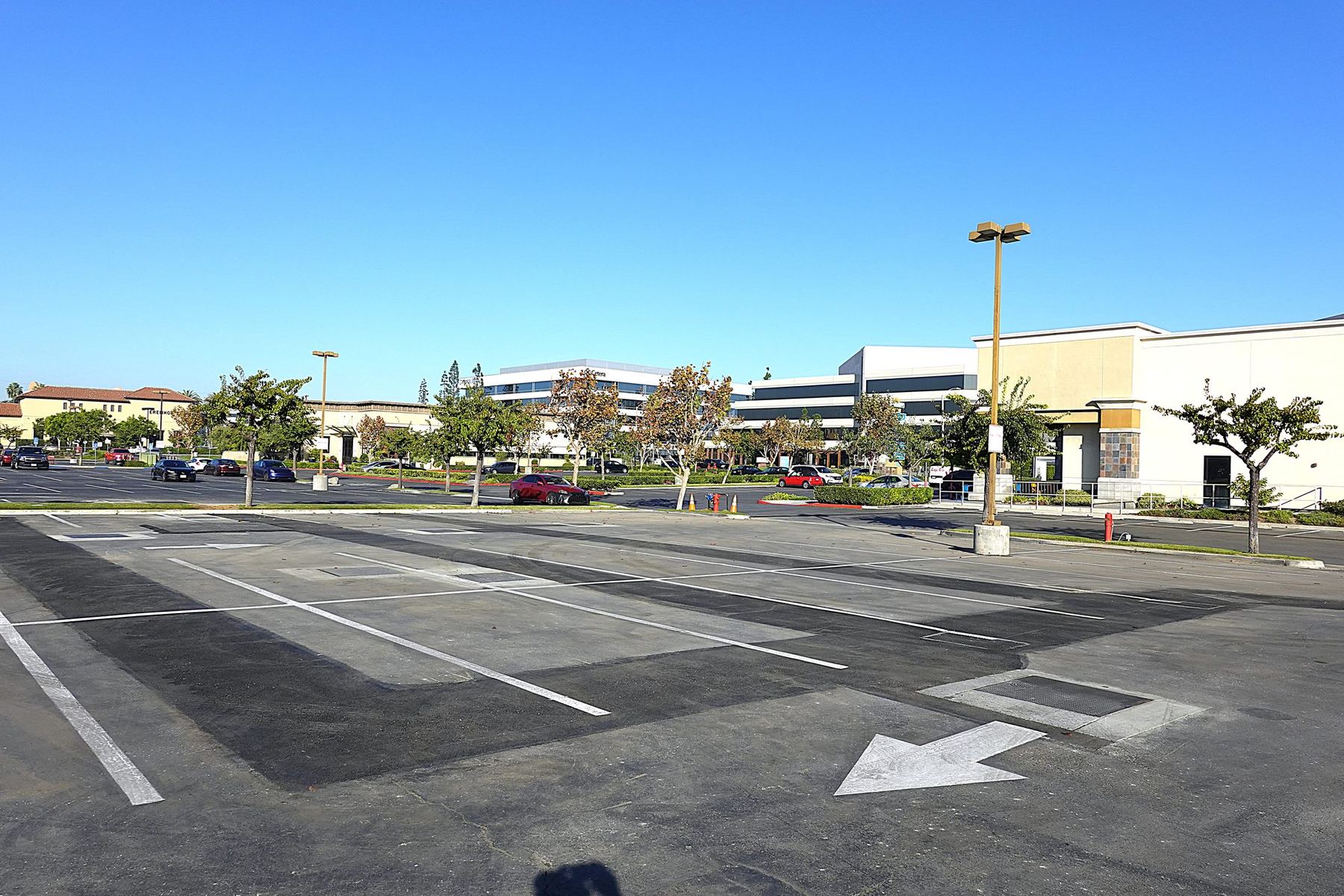 Restored parking lot above a completed recirculation wellfield, with only flush vault covers visible