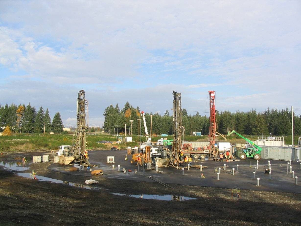 Drill rigs installing a thermal wellfield