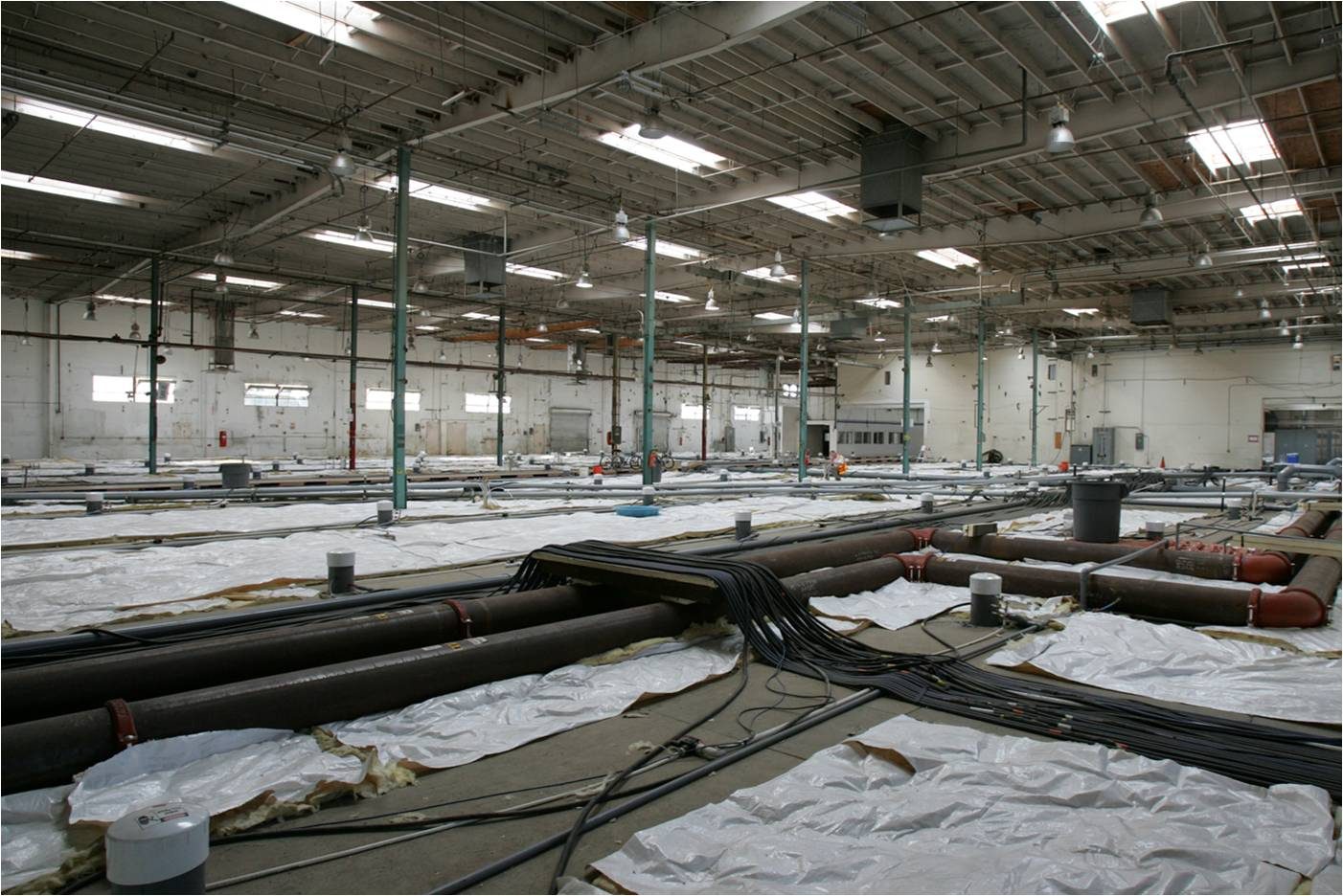 Thermal wellfield and vapor conveyance installed inside a warehouse